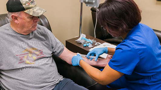 a nurse giving an IV treatment